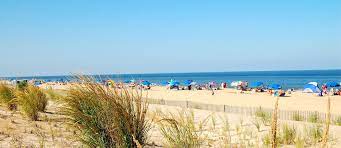 dewey beach white sand and people with umbrellas