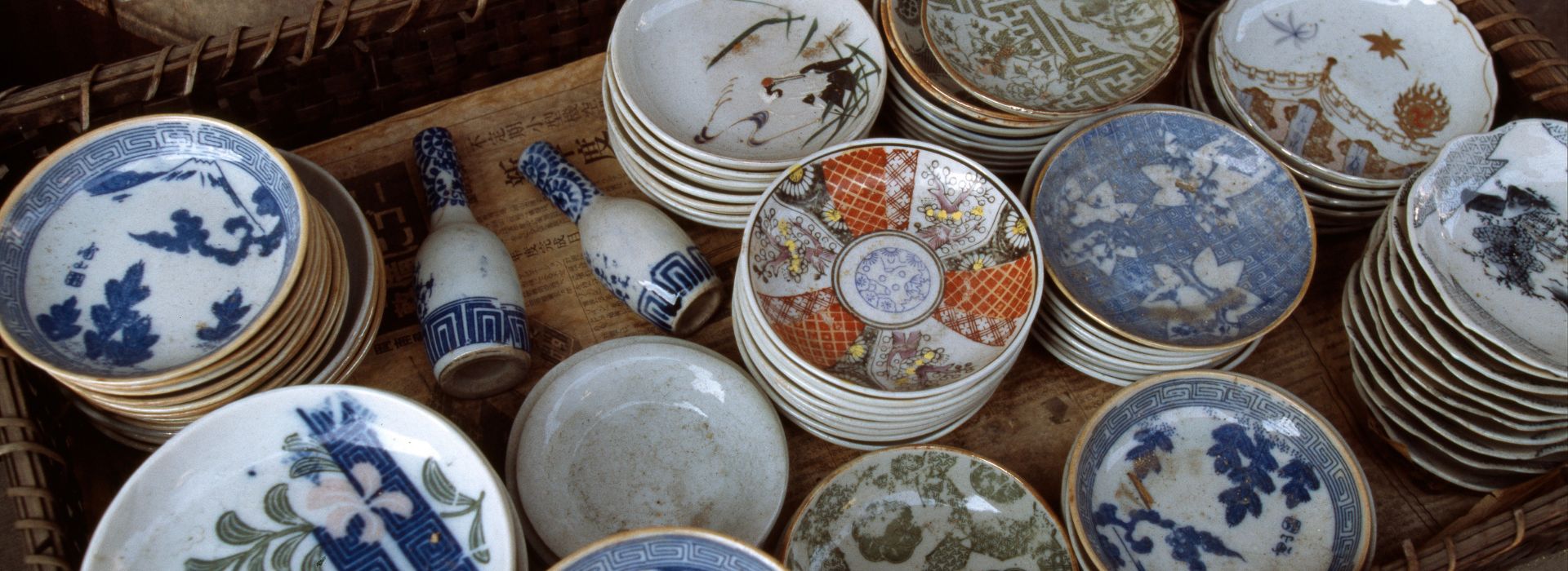 Basket full of colorful antique bowls