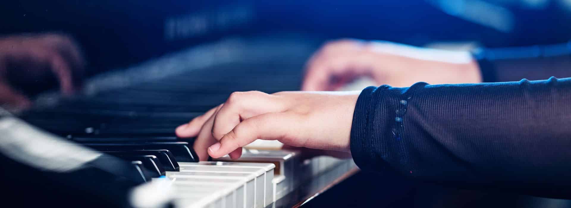 Hands playing the piano