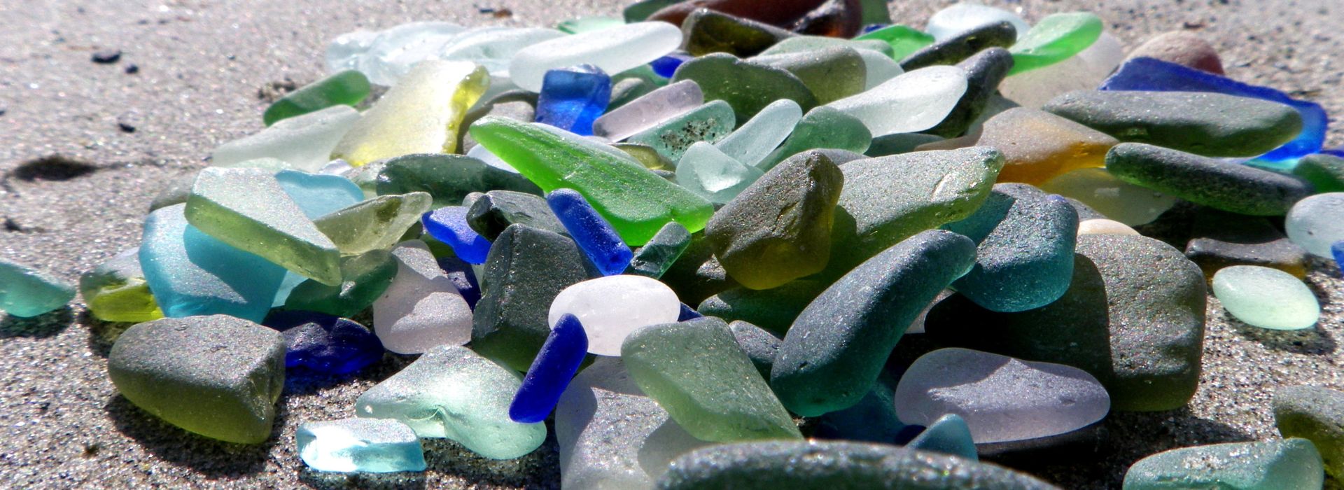 Small pile of colored sea glass on the beach