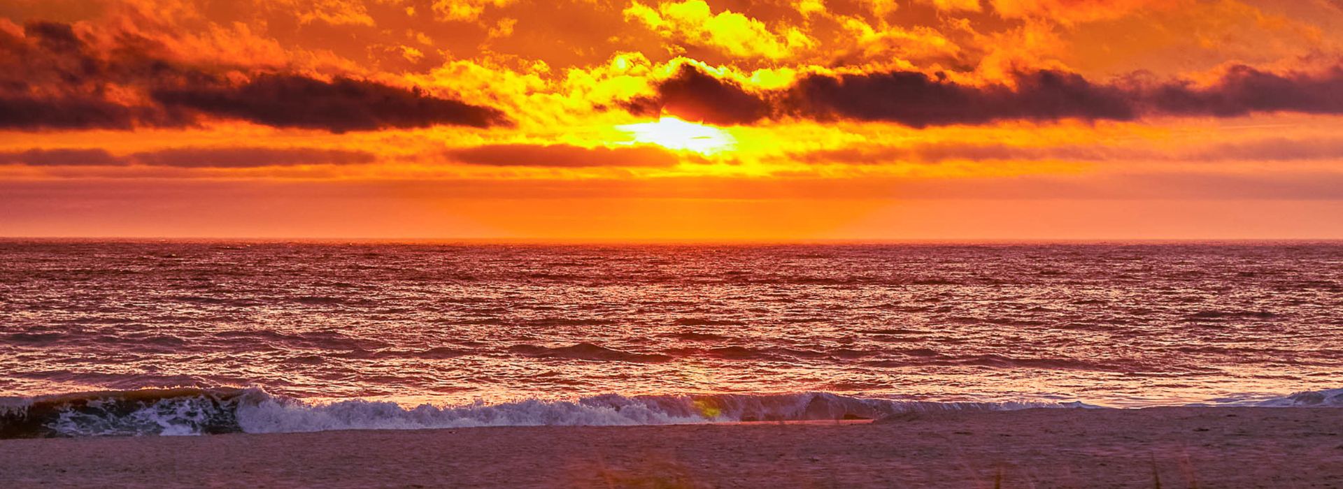 Rich orange sunset over the Atlantic ocean at Rehoboth Beach.