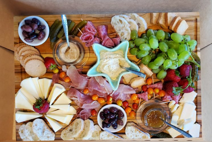 box with meats, cheese, crackers and fruit