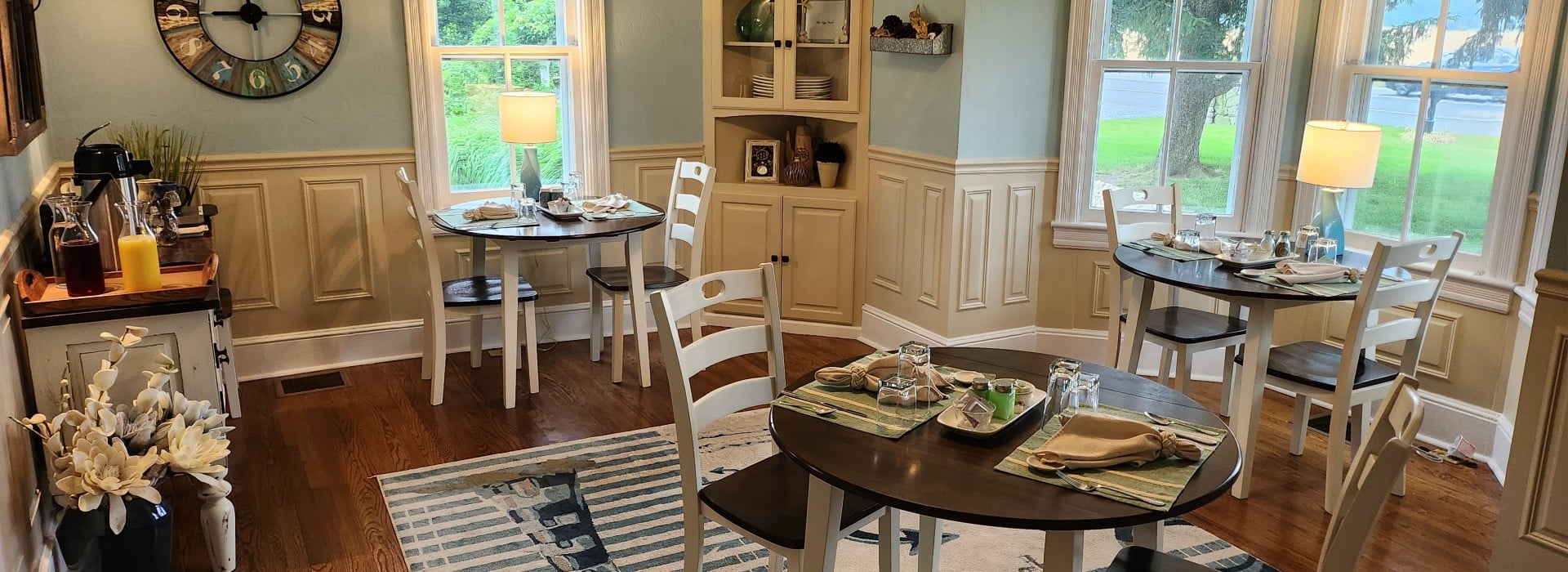 dining room wood floors with 3 white tables