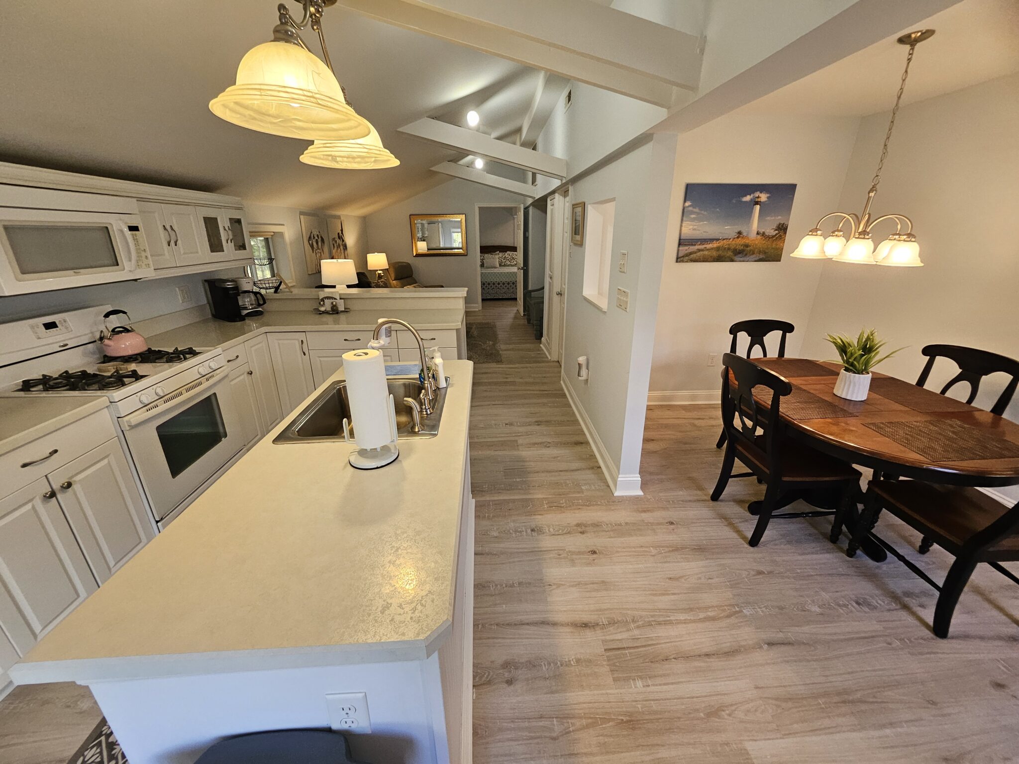 long shot of the apt, white cabinets.