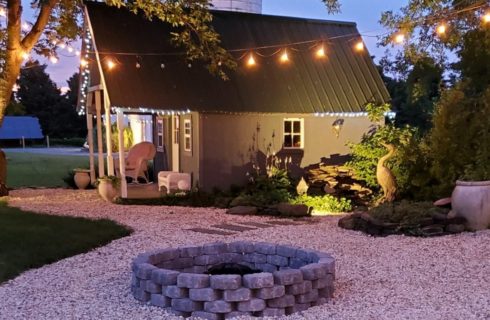 green grass with grey cinders fireplace