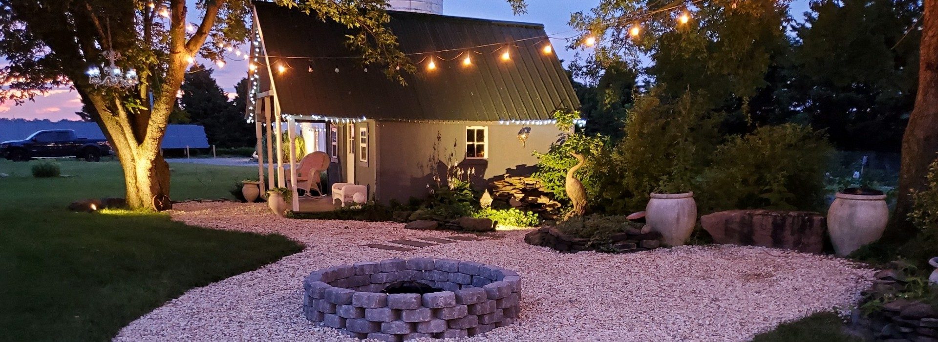 fire pit with stone all around and grey chairs