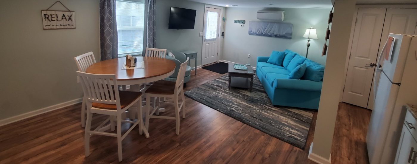 blue couch with wood and white table