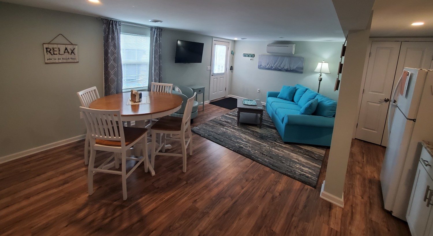 blue couch with wood and white table