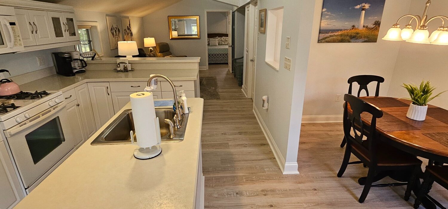 shot of the white kitchen and light colored wood floors