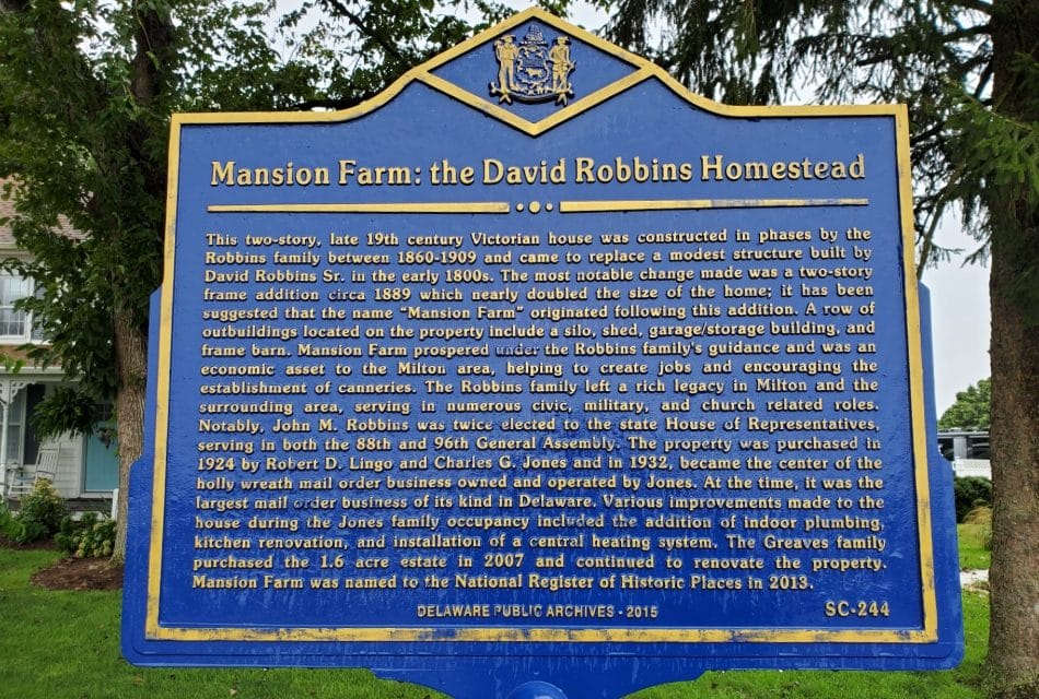 Dark blue sign about the historical Inn