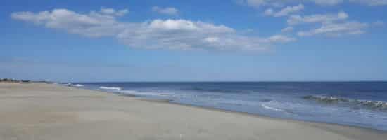 Sandy beach with ocean waves