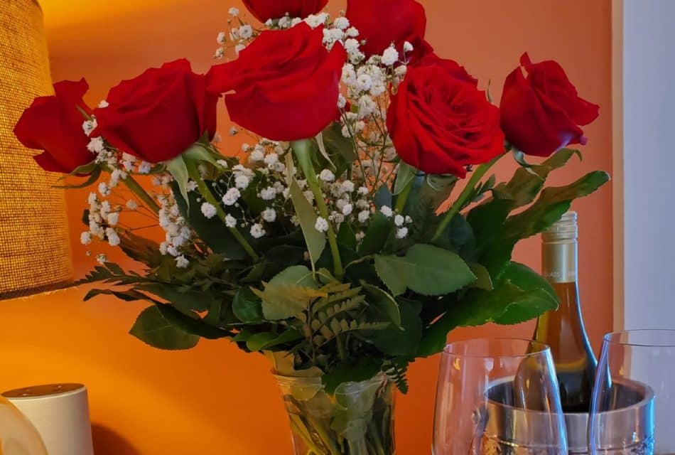Red roses with a bottle of red wine