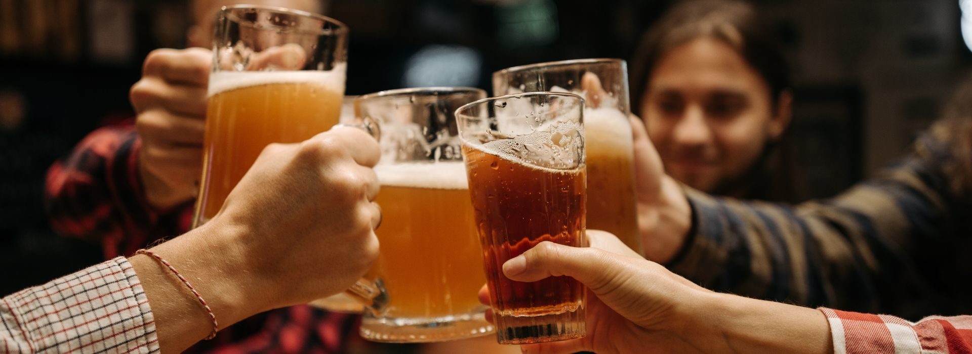 Group of people clinking beer mugs