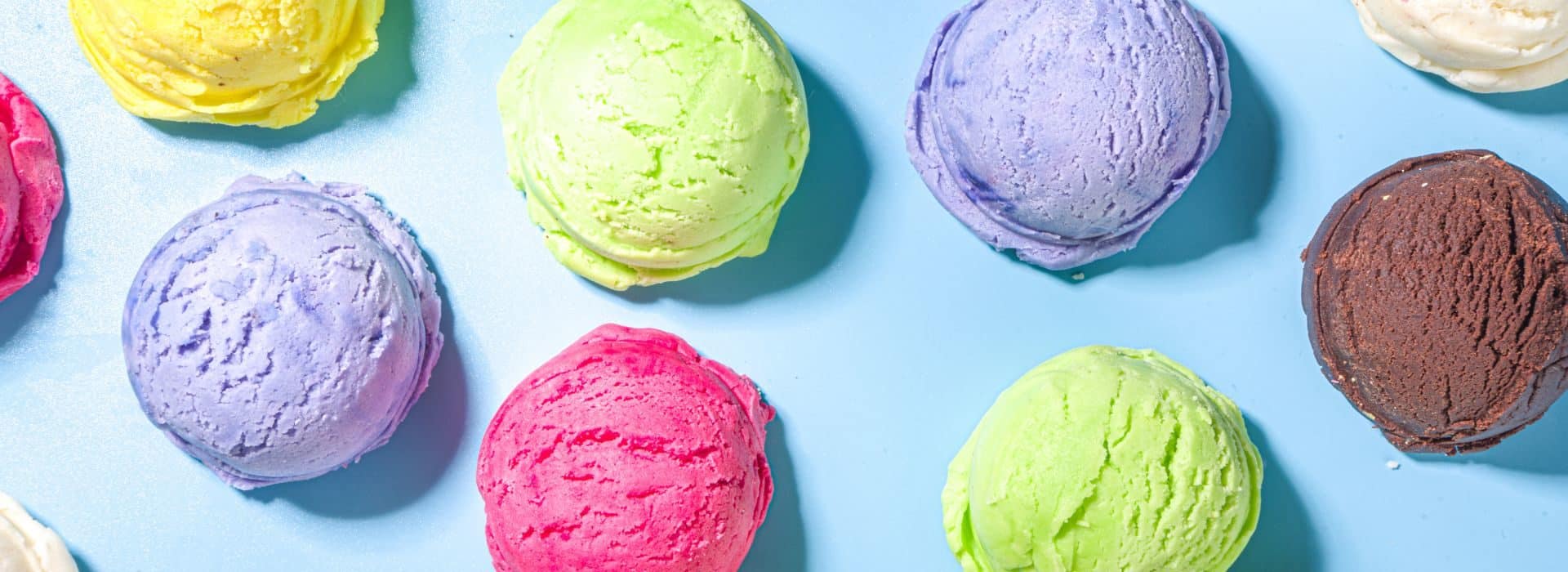 Single scoops of different colorful ice cream flavors.