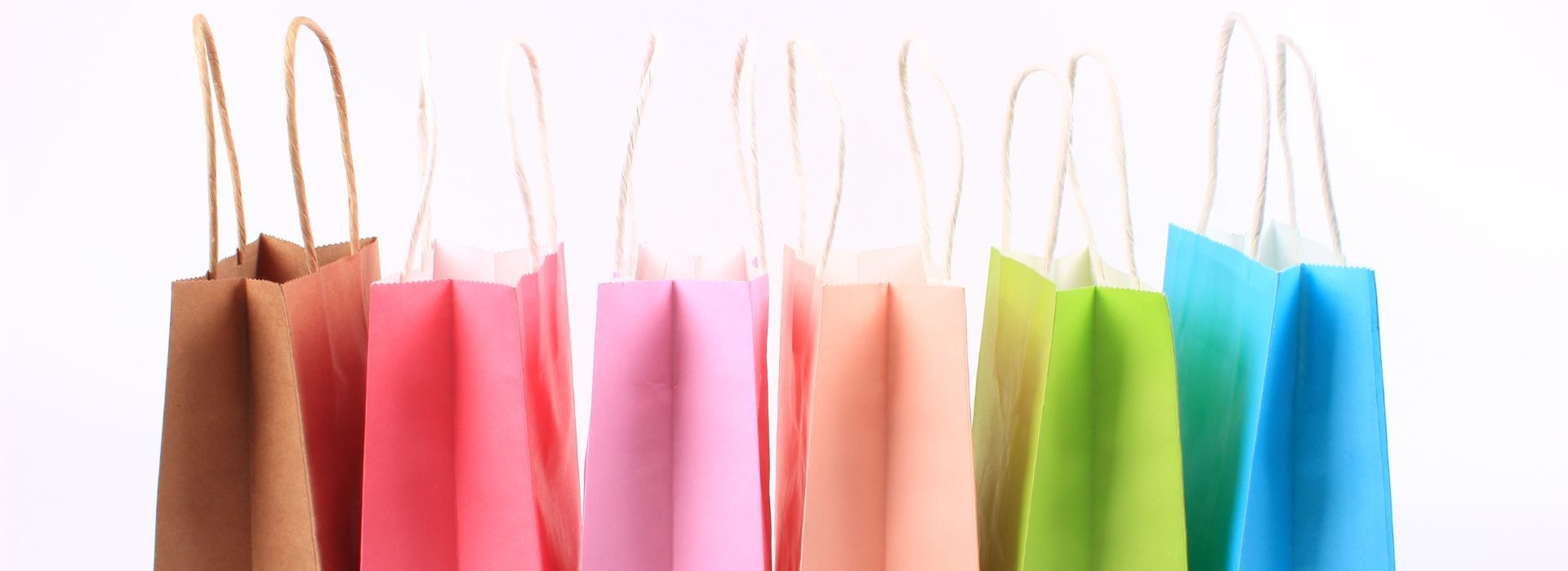 Row of pastel colored shopping bags