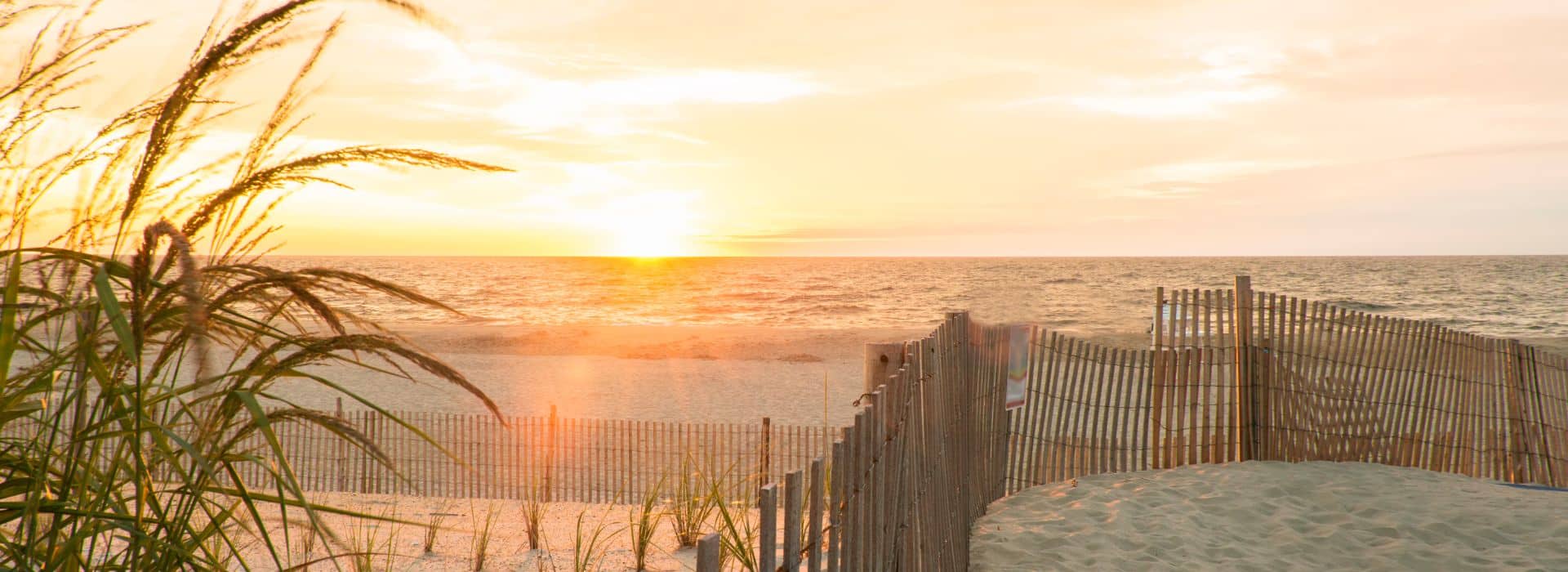 Warm, golden sunrise at peaceful and sandy Bethany Beach