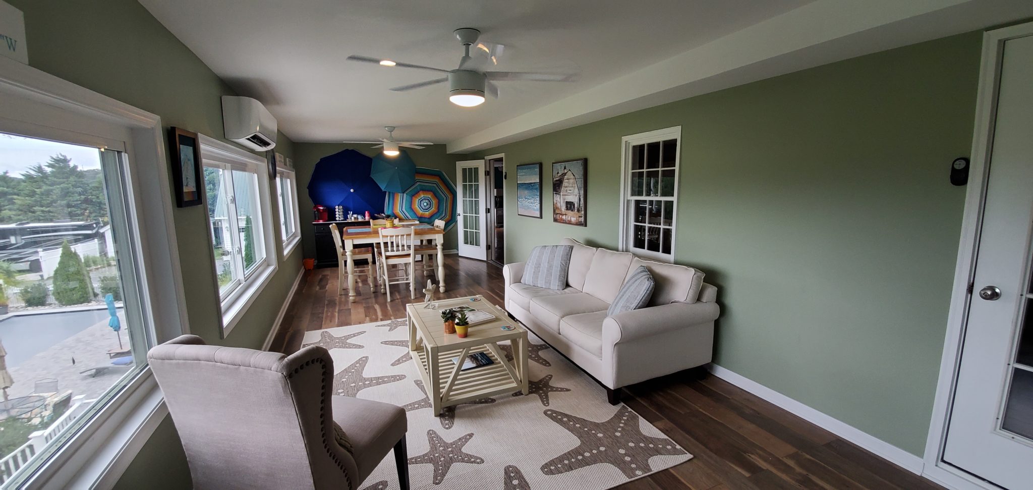 Sunset porch with green walls and a white couch