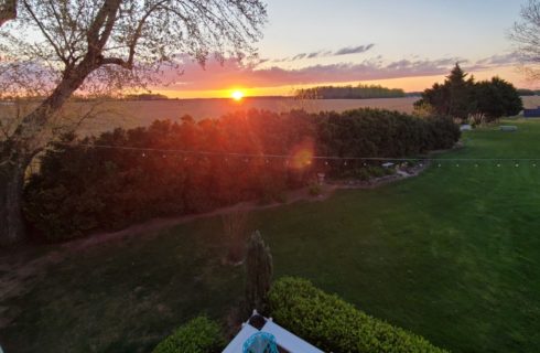 sunset from the porch with bright orange colors